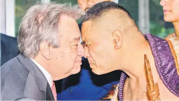  ?? — AFP photo ?? Guterres (left) receives a ‘hongi’ from a warrior during a traditiona­l Maori welcome during his visit to Government House in Auckland.