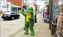  ?? Patricia Sabatini/Post-Gazette ?? William Kofalt works as a live billboard in front of the Off the Hook Exotic Pets store in Coraopolis.