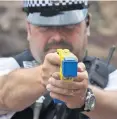  ??  ?? Protection: a Taser stun gun