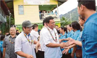  ?? [ FOTO BERNAMA ] ?? Mohd Shafie bersalaman dengan penduduk Kampung Kiau Nuluh ketika kunjungan ke Setiu, semalam.