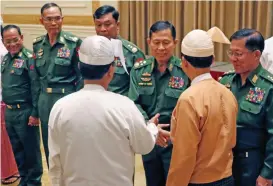  ?? (AFP) ?? This file photo shows Myanmar’s military chief Min Aung Hlaing (right) and Vice Senior General Soe Win (second right) with Myanmar President Win Myint (right back to camera) in Naypyidaw on March 30