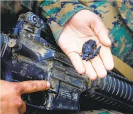  ??  ?? Pfc. Emily Sandoval shows off her Eagle, Globe and Anchor pin that she earned Thursday after completing the Crucible exercise at Camp Pendleton.