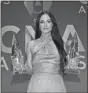  ??  ?? Singer-songwriter Kacey Musgraves poses with awards for female vocalist of the year and music video of the year.