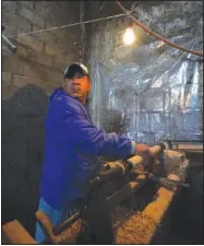  ?? ?? Tranquilin­o Gabriel works Jan. 19 on decorative wood spindles using a primitive lathe and a nail-studded piece of wood in Comachuen.