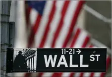  ?? SETH WENIG — THE ASSOCIATED PRESS ?? A street sign is displayed at the New York Stock Exchange in New York, Monday, Nov. 23. Stocks are off to a weak start on Wall Street as investors keep a cautious eye on Washington, where lawmakers appear to be getting close to an agreement on supplying more badly needed aid for the economy. The S&P 500 was down 0.1% in the first few minutes of trading Wednesday, Dec. 16.