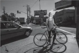  ?? Jay L Clendenin/Los Angeles Times/Associated Press ?? In this photo taken on Nov. 3, 2014, hit-and-run victim Emily Ryan is photograph­ed at the intersecti­on of Main and Daly streets, the location where she was hit while riding her bike. Ryan was struck by a car turning left onto Daly as she was crossing...