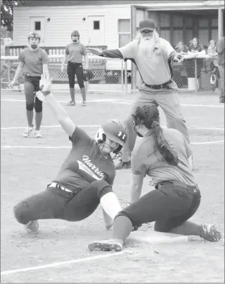  ?? Fred Conley • Times-Herald ?? A Harris Plumbing base runner slides safely into third base with a triple in the first inning of a second round game played Saturday at the Bonnie Burton girls softball tournament.