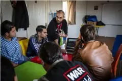  ?? (Bel Trew) ?? Syrian teenagers in Zaatari refugee camp watch a video from London school pupils as part of The Independen­t twinning programme