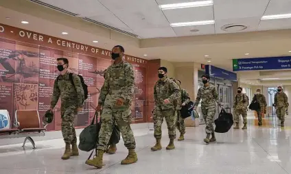  ?? Photos by Jerry Lara / Staff photograph­er ?? Army Pvt. Kevin Rinke, 18, left, of Spanaway, Wash., and Pfc. Marlon Brownfield, 19, of Hampton, Ga., arrive with other soldiers at San Antonio Internatio­nal Airport on their way to their holiday break.