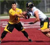  ?? BARRY GRAY, THE HAMILTON SPECTATOR ?? Injured starting quarterbac­k Zach Collaros got some work handing off the ball during drills at Ticat training camp. He has signed with the team through the 2018 season.