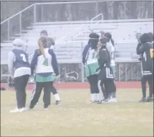  ?? STAFF PHOTO BY TED BLACK ?? St. Charles High School girls lacrosse defenders await the draw on March 13 in a scrimmage against visiting Gwynn Park of Prince George’s County. St. Charles had less trouble with the Yellow Jackets than they did navigating through the snowy, blustery...