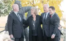  ?? LIAM RICHARDS/THE CANADIAN PRESS ?? Marty Howe, left, son of Gordie Howe, his sister Cathy Howe, and brothers Mark and Murray hug following the interment Sunday of Gordie and Colleen Howe’s ashes in Saskatoon.