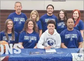  ?? PDN photo by Tom Firme ?? Pocola’s Garrett Scott signs with the University of Arkansas-Fort Smith while seated with sister Mika Scott and parents Amy and Greg Scott. In back are Mike and Susie Lairamore, Sadie Scott and David and Katherine Chitwood.