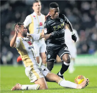  ?? Simon Cooper ?? Koby Arthur takes on MK Dons’ Baily Cargill during Saturday’s clash