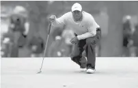  ?? JASON GETZ/AP ?? Tiger Woods prepares to putt on the third green during the third round of the Masters on Saturday in Augusta, Ga.