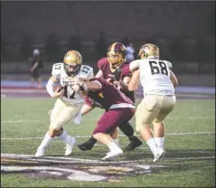  ?? The Sentinel-Record/Grace Brown ?? TAKING HIM DOWN: Lake Hamilton defender Luke Dodd (53) works to take down Hot Springs quarterbac­k Isaac Shelor (17) in Friday’s game at Bank OZK Field.