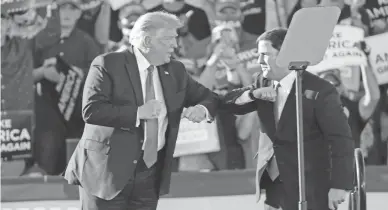  ?? MICHAEL CHOW/THE REPUBLIC ?? President Donald Trump elbow bumps Arizona Gov. Doug Ducey during a campaign rally in Tucson in October.