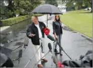  ?? PABLO MARTINEZ MONSIVAIS — THE ASSOCIATED PRESS ?? President Donald Trump and first lady Melania Trump walk across the South Lawn of the White House in Washington, Monday to board Marine One helicopter for a short trip to Andrews Air Force Base, Md., en route to Florida to tour areas the devastatio­n left behind from Hurricane Michael last week.