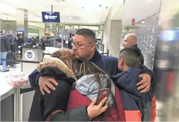  ?? NIRAJ WARIKOO/USA TODAY NETWORK ?? Jorge Garcia hugs his family Jan. 15 before being deported from Detroit to Mexico.