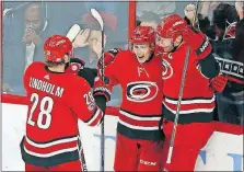  ?? [KARL B DEBLAKER/THE ASSOCIATED PRESS] ?? Carolina’s Teuvo Teravainen, center, celebrates his goal with teammates Jordan Staal, right, and Elias Lindholm during Monday’s game against Dallas.