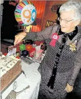  ??  ?? May Bishop cuts her birthday cake.