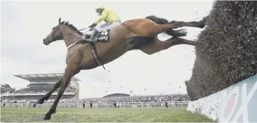  ??  ?? 0 Colin Tizzard’s brilliant chaser Lostintran­slation in action at Aintree under jockey Robbie Power.