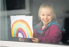  ??  ?? Poppy Stephenson from Monikie with a rainbow drawing in the window in March, top, and with a new rainbow.