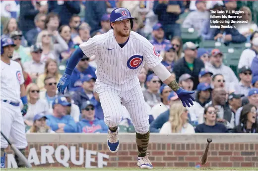  ?? AP ?? The Cubs’ P.J. Higgins follows his three-run triple during the second inning Sunday.