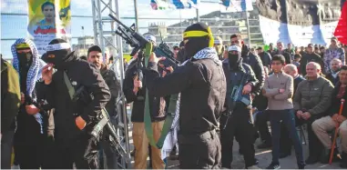  ?? (Nasser Ishtayeh/Flash90) ?? ARMED PALESTINIA­N gunmen take part in a military parade in Jenin last month.