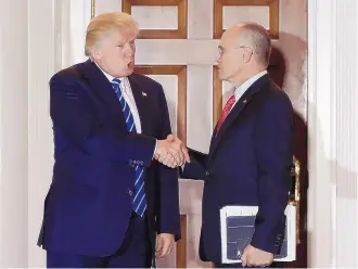  ?? CAROLYN KASTER/ASSOCIATED PRESS ?? President-elect Donald Trump meets with Andy Puzder, chief executive of CKE Restaurant­s, on Nov. 19. Trump has tapped Puzder to head the Labor Department.