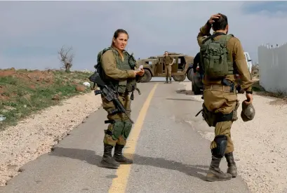  ?? AFP ?? Israeli soldiers block a road in the Israeli-annexed Golan Heights amid heightened tensions with Syria after Israel struck a dozen Syrian and Iranian targets inside Syria in large-scale raids. —