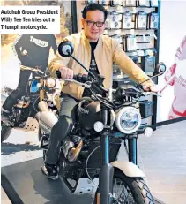  ??  ?? Autohub Group President Willy Tee Ten tries out a Triumph motorcycle.