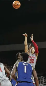  ?? Steve Gonzales / Houston Chronicle ?? Guard Rob Gray, who led Houston with 34 points, rises above the crowd to score. He had five of the Cougars’ AAC-record 18 3-pointers against Tulsa.
