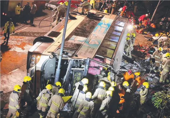  ?? Picture: AFP ?? Firefighte­rs and emergency personnel work to rescue survivors after a double-decker bus toppled in Hong Kong.