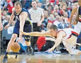  ?? CRAIG MITCHELLDY­ER/ASSOCIATED PRESS ?? Pat Connaughto­n dives for the ball in front of Utah’s Joe Ingles during the Trail Blazers’ Jan. 13 win over the Jazz. Connaughto­n is averaging 3 minutes per game for Portland.