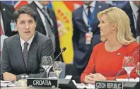  ?? CP PHOTO ?? Canadian Prime Minister Justin Trudeau sits alongside Croatian President Kalinda Grabar-Kitarovic during a working dinner meeting at the NATO headquarte­rs during a NATO summit of heads of state and government in Brussels on Thursday.