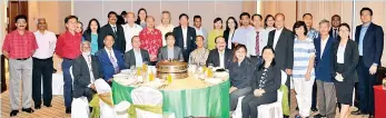  ??  ?? Tan (seated fourth from left) among the guests and members attending the Baha’i video presentati­on.