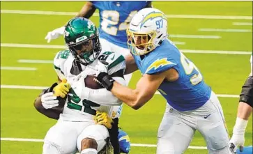  ?? Jae C. Hong Associated Press ?? DEFENSIVE END Joey Bosa of the Chargers helps tackle New York Jets running back La’Mical Perine.