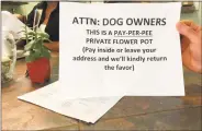  ?? Mary E. O’Leary / Hearst Connecticu­t Media ?? A sign in front of Duc’s Place, a New Haven restaurant, used humor to shame dog walkers whose pets urinate on the flower pot outside the restaurant.