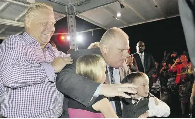  ?? J.P. Moczulski for National Post ?? Doug, left, and Rob Ford and his children pose for a photograph on Sept. 27 as the mayor
makes his first public appearance following his first round of chemothera­py.