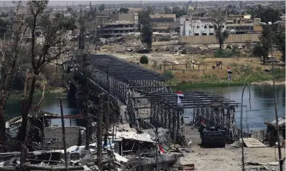  ??  ?? A BRIDGE near Mosul’s Old City seen yesterday shows some of the destructio­n caused by recent clashes.