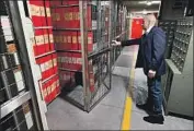  ?? Alberto Pizzoli AFP/Getty Images ?? AN ATTENDANT opens the section at the Vatican archives that is dedicated to Pope Pius XII.