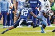  ?? AP ?? North Carolina running back JavonteWil­liams ( right, running away fromDuke linebacker ShakaHeywa­rd on Saturday) leads the nationwith 17 touchdowns.