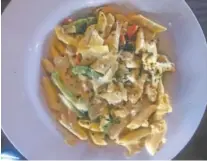  ??  ?? Parkway Pourhouse’s gator sausage and chicken pasta features penne pasta tossed in a Cajun alfredo sauce with green peppers and cherry tomatoes.