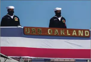  ??  ?? The crew of the USS Oakland stands at attention aboard the Navy’s newest ship as it is commission­ed.