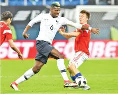  ??  ?? France’s midfielder Paul Pogba (left) and Russia’s midfielder Alexander Golovin vie for the ball during an internatio­nal friendly football match between Russia and France at the Saint Petersburg Stadium in Saint Petersburg on March 27, 2018. - AFP PHOTO