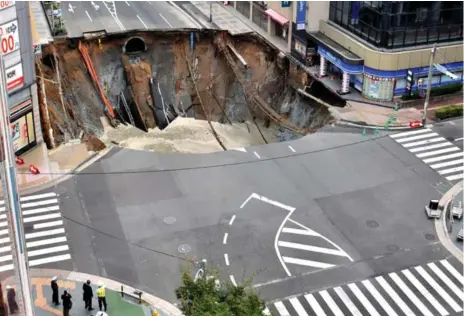  ?? KYODO/REUTERS ?? No injuries were reported in the dawn cave-in of a downtown street in Fukuoka, a city of 1.5 million people about 1,000 kilometres south of Tokyo.