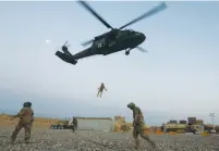  ?? (Omar Sobhani/Reuters) ?? A NAVY CORPSMAN and other US soldiers take part in a Medevac helicopter exercise in Helmand Province, Afghanista­n, on July 6.