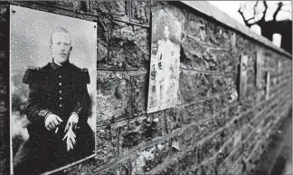  ?? VIRGINIA MAYO/AP PHOTOS ?? A photo of French WWI soldier Augustin Trebuchon hangs on a wall last month outside a cemetery in VrigneMeus­e, France. Trebuchon is recorded as the last French soldier to die in the war. He died Nov. 11, 1918, even though his tombstone says Nov. 10.