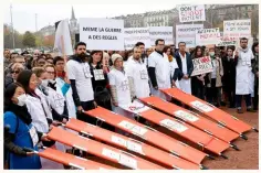  ??  ?? ABOVE: Médecins Sans Frontières staff protest in Geneva a month after the attack. MSF is calling for an independen­t inquiry.